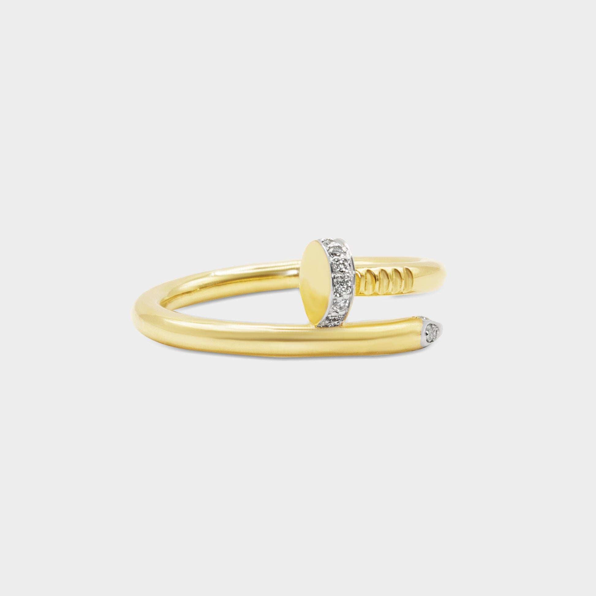 Gold ring with a unique design on a light gray background