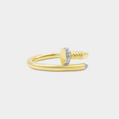 Gold ring with a unique design on a light gray background